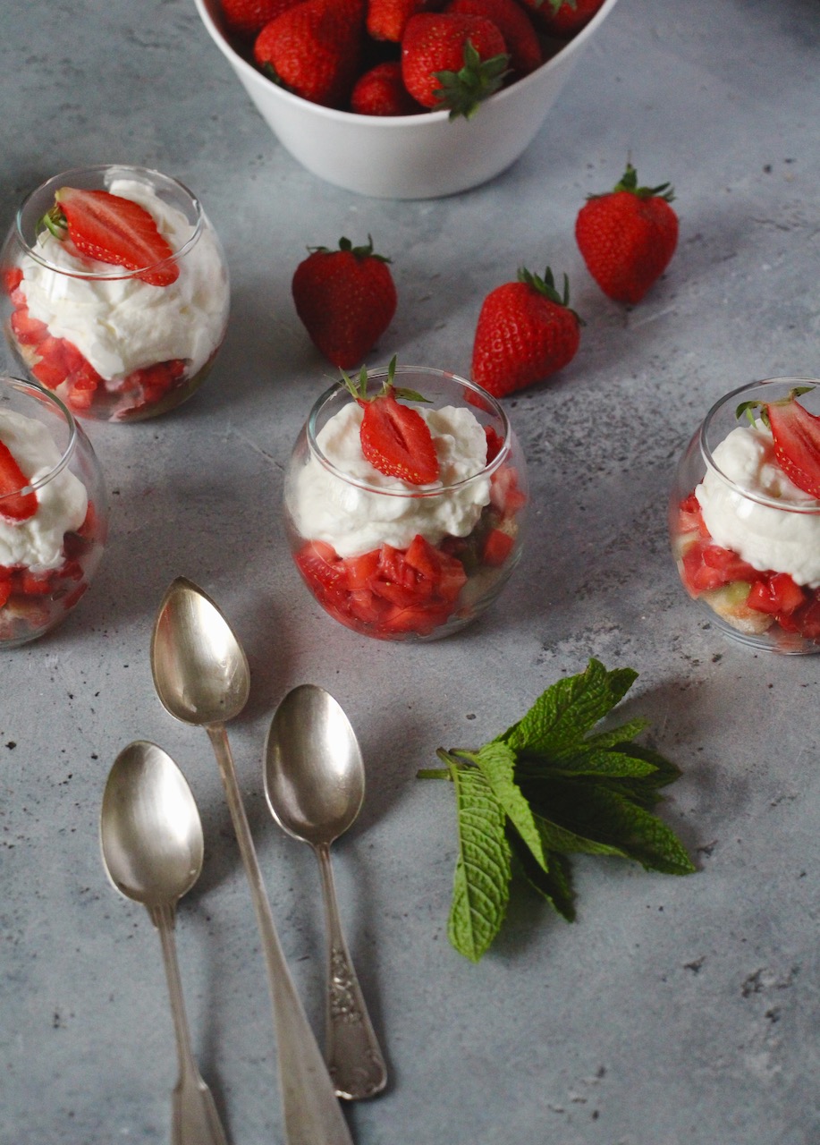 Elegant verrines with creamy mousse over diced strawberries and rhubarb, a gourmet strawberry rhubarb dessert