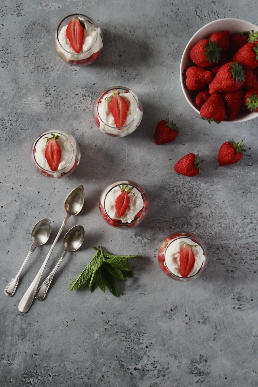 Elegant strawberry rhubarb dessert verrines on a textured gray background