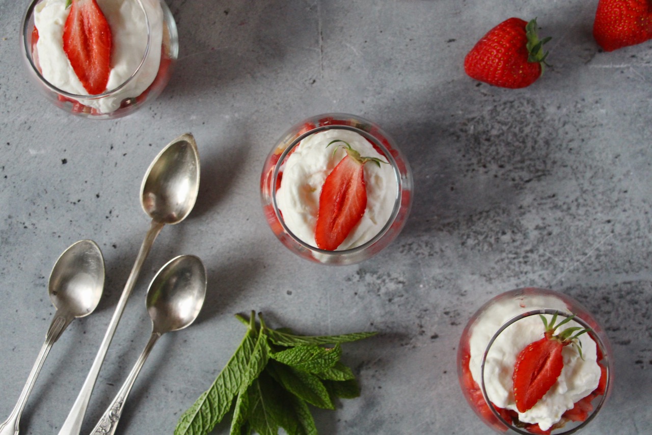 Elegant strawberry rhubarb dessert verrines with cream and fresh strawberries