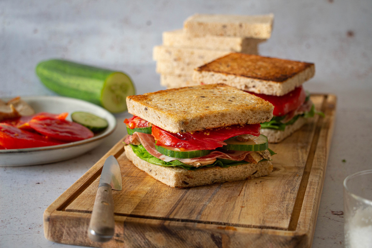 Golden toasted bread filled with chicken, tomatoes, and cucumbers in this chicken sandwich