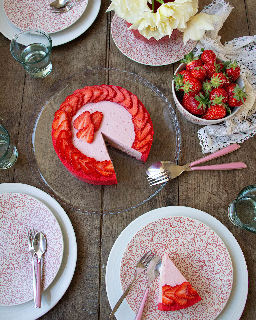 Strawberry Bavarian cream on a glass plate, garnished with slices of fresh strawberries