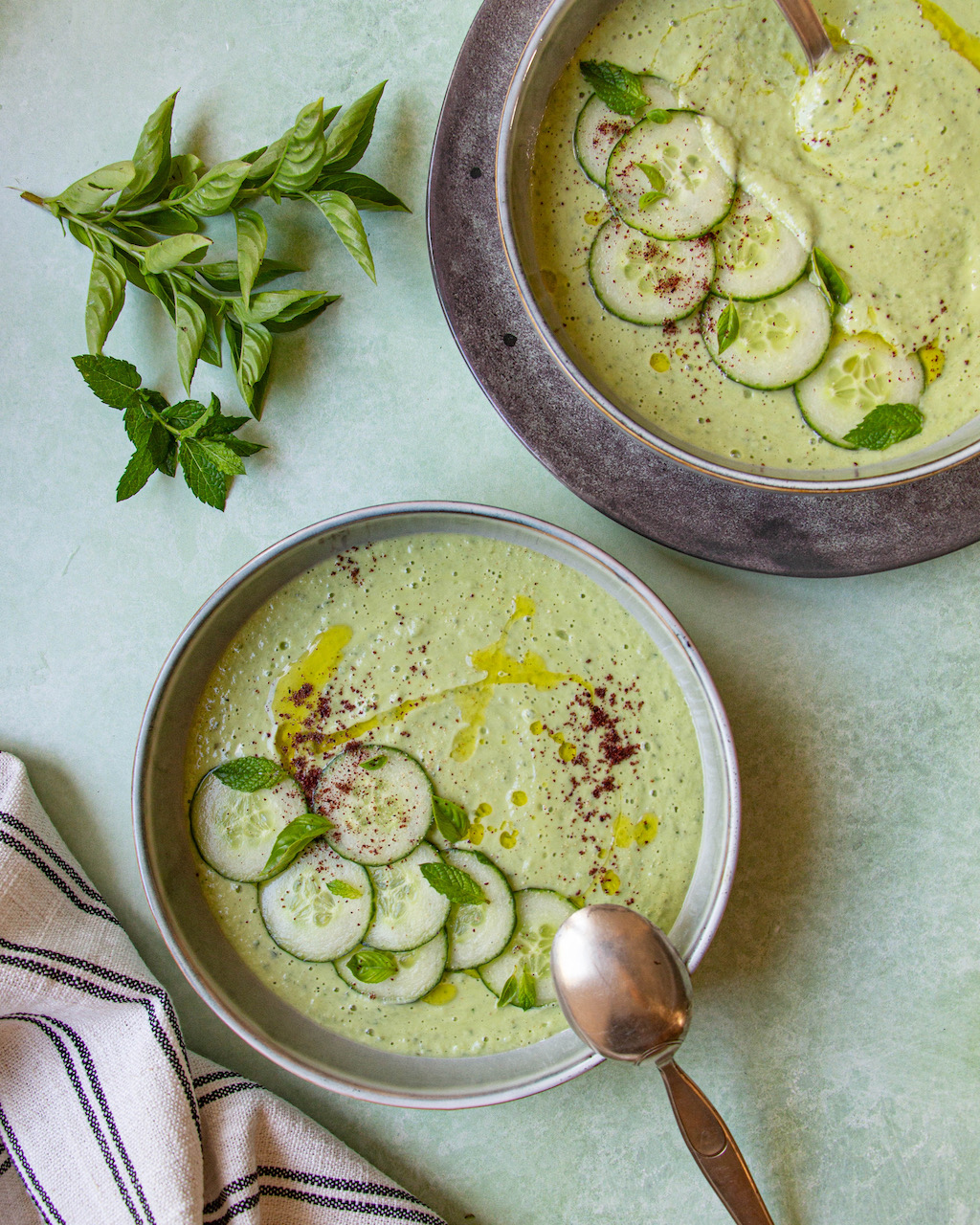 Creamy cucumber gazpacho garnished with cucumber slices and fresh herbs