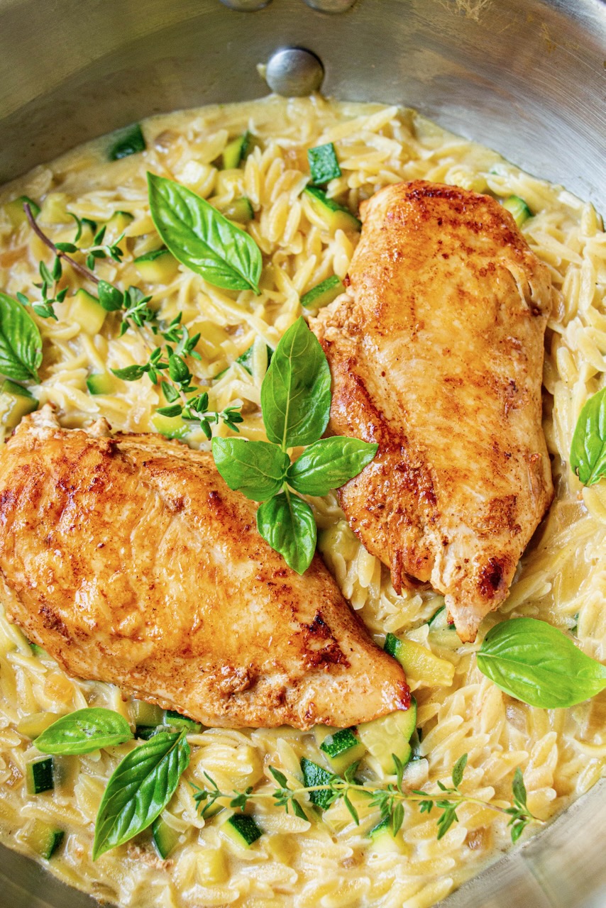 Golden chicken on creamy orzo with zucchini and fresh basil, a delicious orzo recipe
