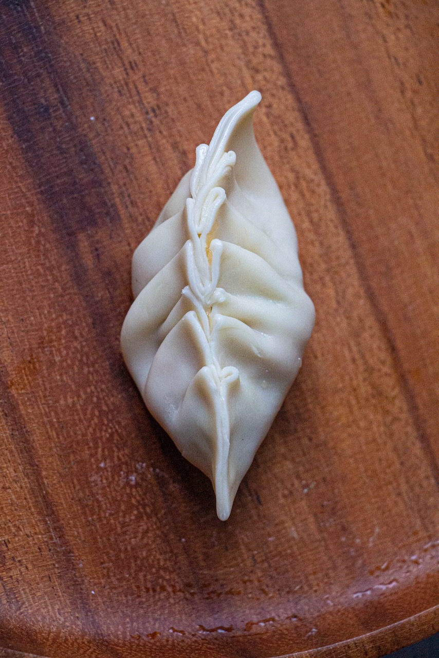 Folding gyozas with pleats oriented in the same direction